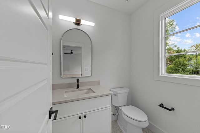 bathroom featuring vanity, toilet, and a healthy amount of sunlight