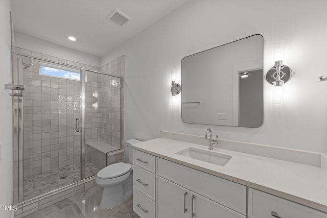 bathroom with vanity, a shower with shower door, and toilet