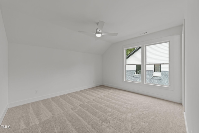 bonus room with lofted ceiling, ceiling fan, and light carpet