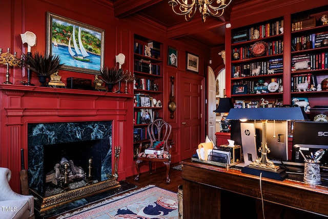 office area featuring built in features, a notable chandelier, a premium fireplace, and dark hardwood / wood-style flooring