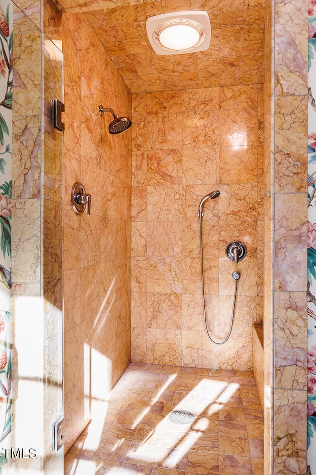 bathroom with a tile shower