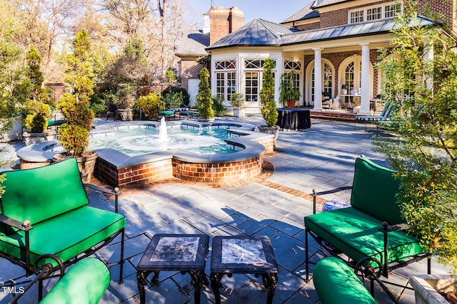 view of patio / terrace with french doors and a jacuzzi