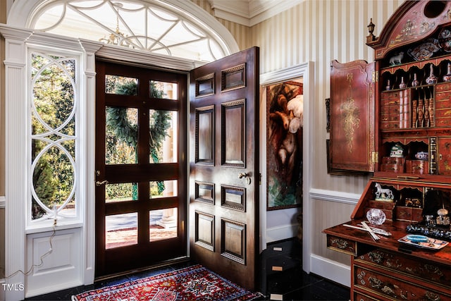 tiled entryway featuring ornamental molding