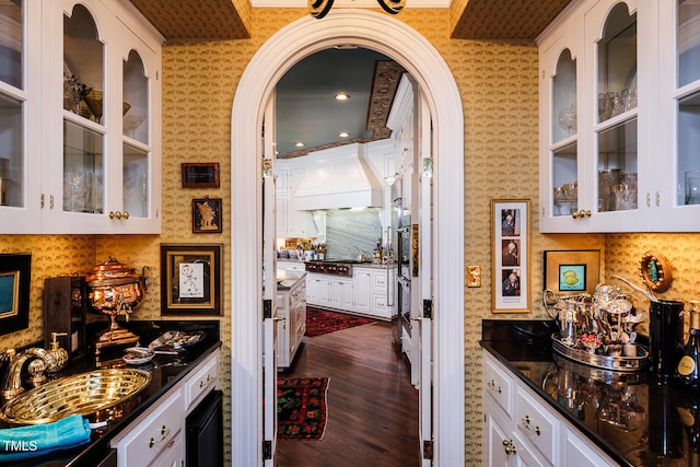 kitchen with sink, white cabinets, dark hardwood / wood-style flooring, and premium range hood