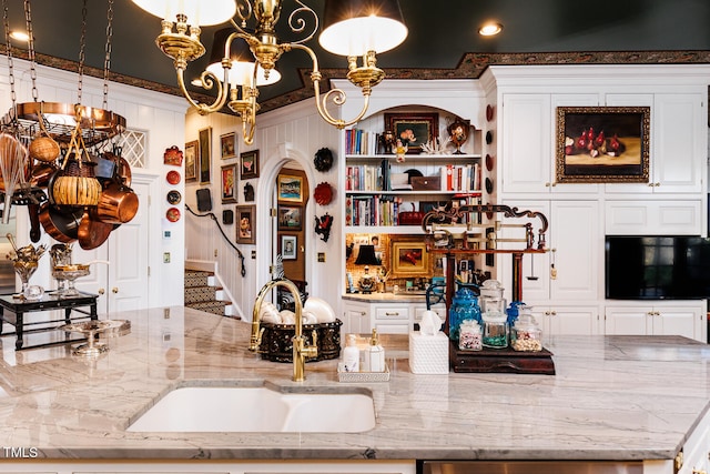 bar featuring white cabinets and light stone countertops