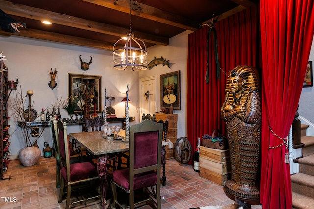 dining space featuring a notable chandelier and beamed ceiling