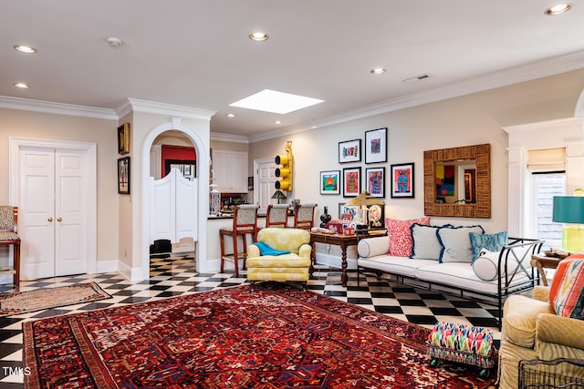 tiled living room with a skylight and ornamental molding