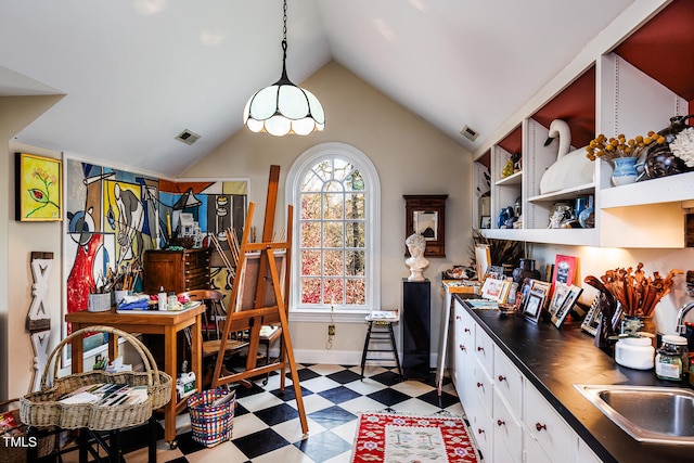 interior space featuring sink, light tile floors, and vaulted ceiling