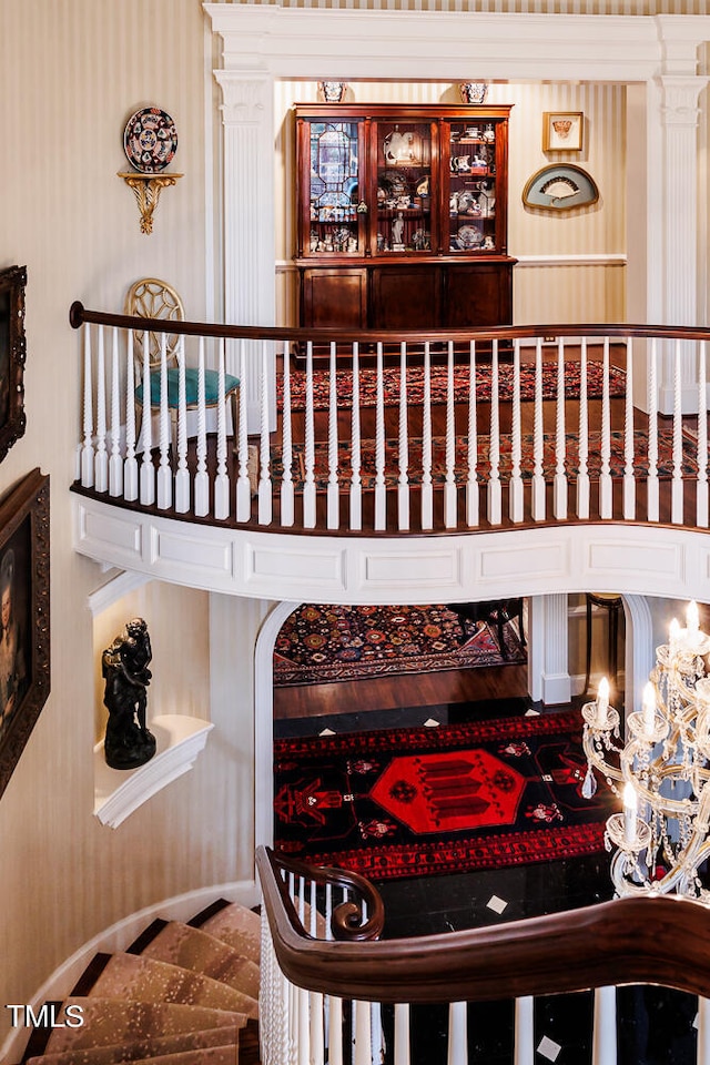 stairs featuring hardwood / wood-style floors