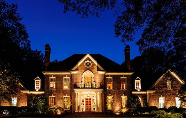 view of front of house featuring a balcony and french doors