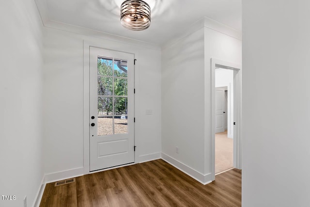 entryway featuring wood-type flooring and crown molding