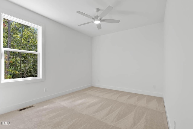 carpeted empty room featuring ceiling fan