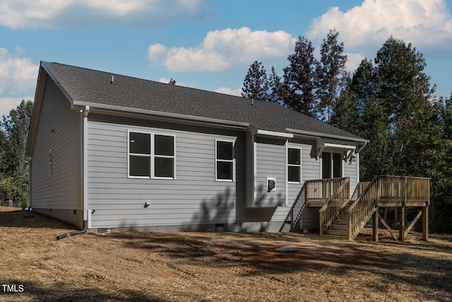 rear view of property featuring a deck