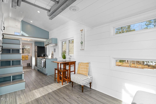 sitting room featuring high vaulted ceiling, beam ceiling, and light wood-type flooring