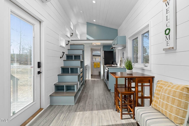 interior space with vaulted ceiling and light hardwood / wood-style flooring