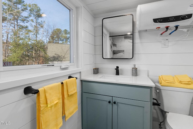 bathroom with toilet and vanity with extensive cabinet space