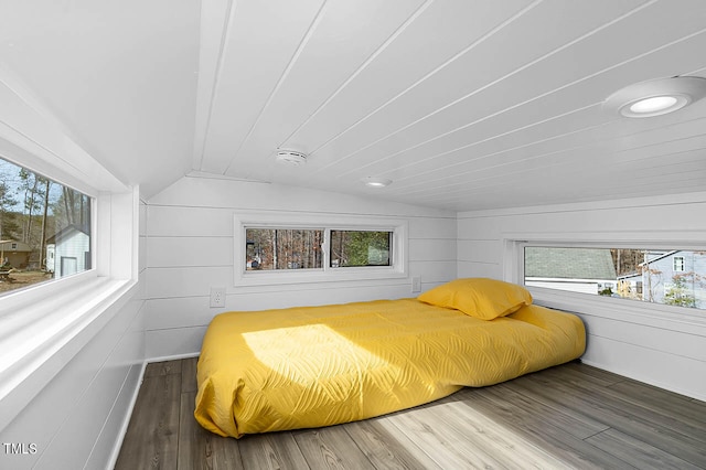 bedroom with hardwood / wood-style floors and vaulted ceiling