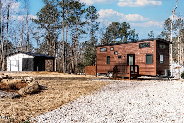 back of house with an outdoor structure