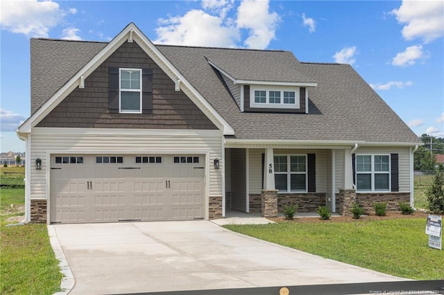 craftsman-style house with a garage and a front lawn