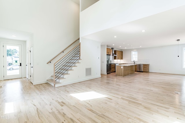 unfurnished living room featuring light wood-type flooring