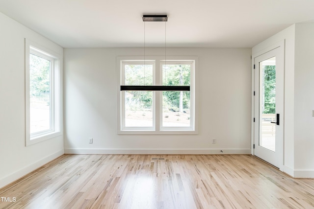 unfurnished room with light hardwood / wood-style floors