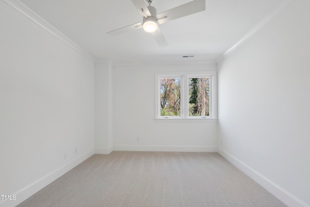 carpeted empty room with ceiling fan and ornamental molding