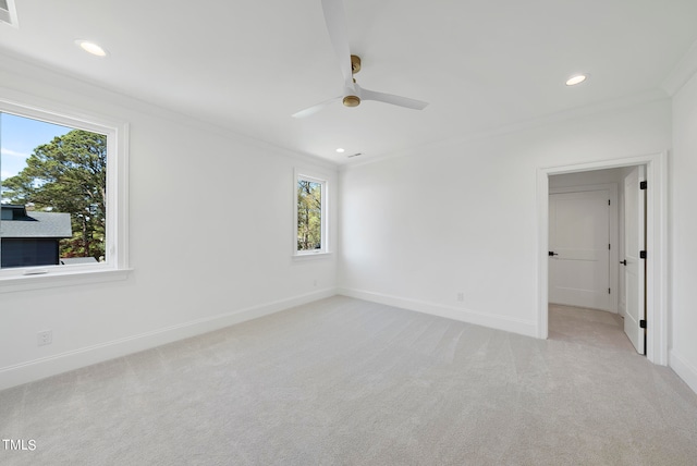 carpeted spare room featuring ceiling fan and ornamental molding