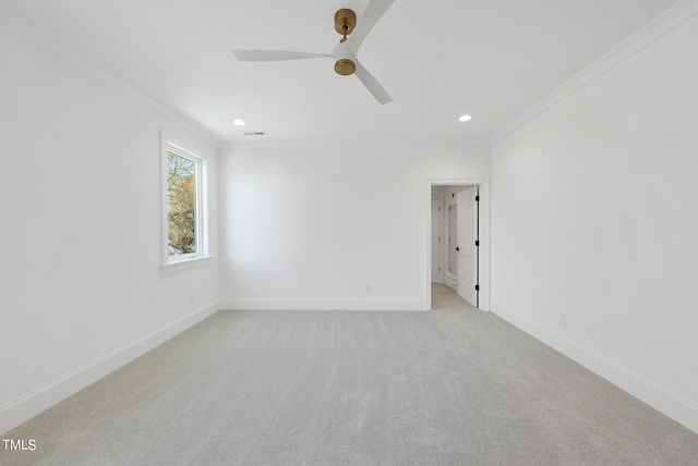 spare room featuring light carpet, ceiling fan, and ornamental molding