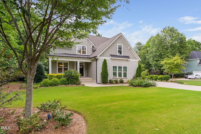 craftsman-style home featuring a front yard and covered porch