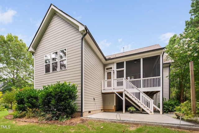 rear view of house featuring a patio area and a sunroom