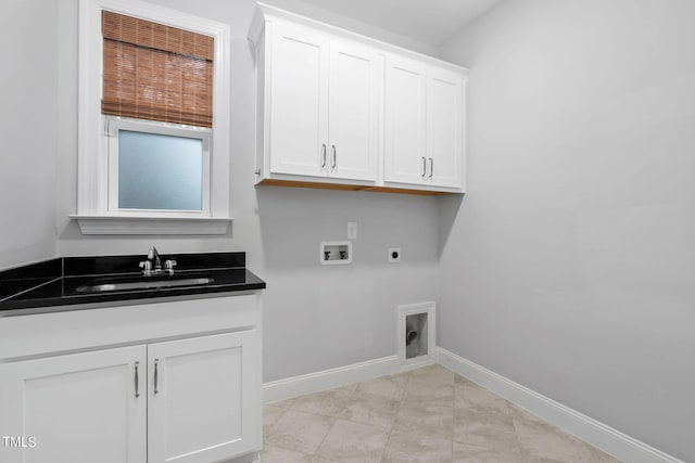 clothes washing area with sink, hookup for a washing machine, cabinets, hookup for an electric dryer, and light tile patterned floors