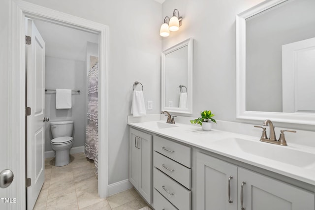 bathroom with tile patterned flooring, vanity, and toilet