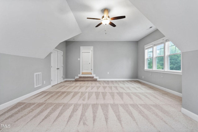 bonus room featuring light colored carpet and ceiling fan