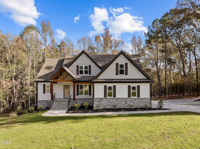 143 Hook Dr Lot 23, Fuquay Varina, NC 27526 - view of front of home featuring stone siding, covered porch, and a front lawn