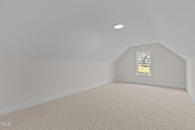 bonus room featuring lofted ceiling and light colored carpet