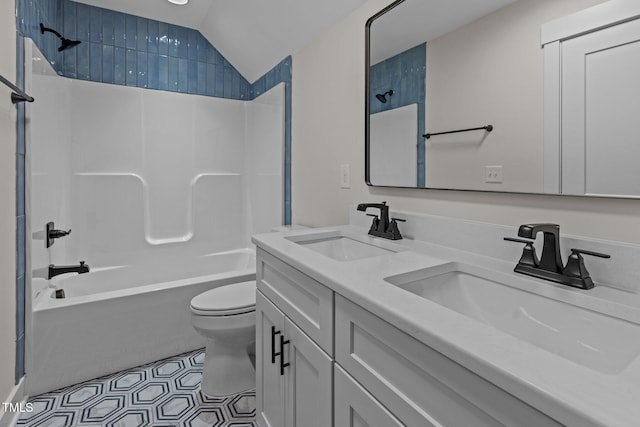 full bathroom featuring  shower combination, tile patterned flooring, vanity, vaulted ceiling, and toilet