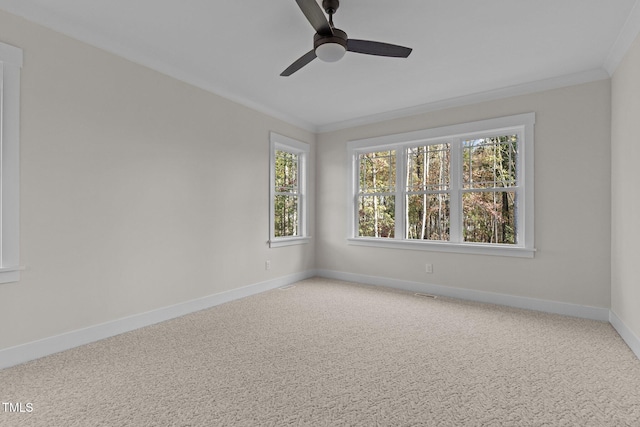 empty room featuring ornamental molding, carpet, and ceiling fan