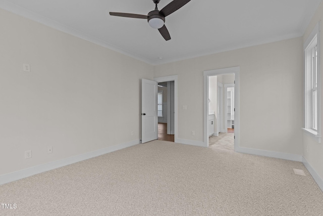 empty room with light carpet, ceiling fan, and ornamental molding