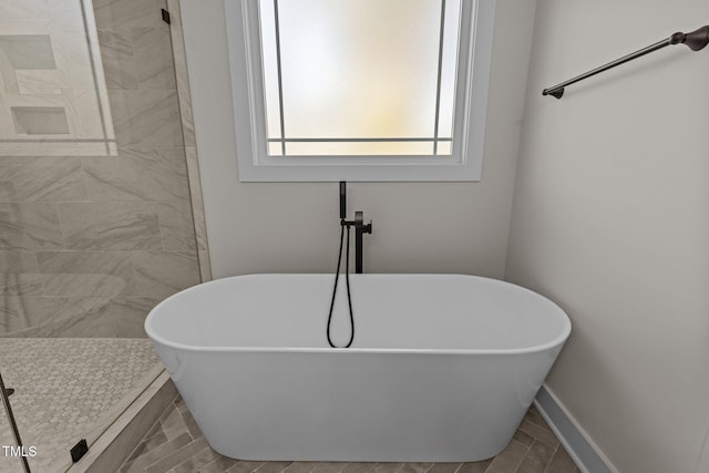 143 Hook Dr Lot 23, Fuquay Varina, NC 27526 - full bath featuring a freestanding tub, wood finish floors, tiled shower, and baseboards