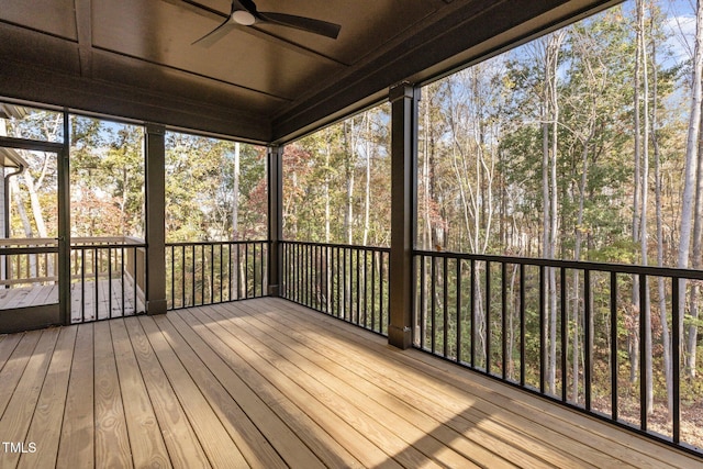 unfurnished sunroom featuring ceiling fan