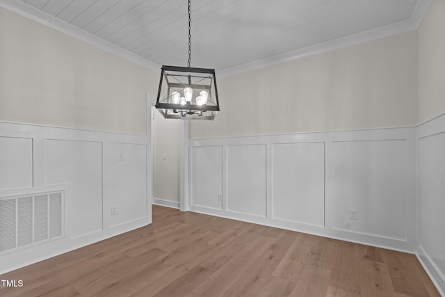 unfurnished dining area with an inviting chandelier, crown molding, light hardwood / wood-style flooring, and wooden ceiling