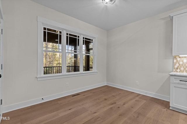 unfurnished dining area with light hardwood / wood-style floors