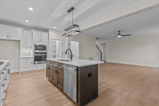 143 Hook Dr Lot 23, Fuquay Varina, NC 27526 - kitchen with stainless steel appliances, a sink, white cabinets, ceiling fan, and recessed lighting