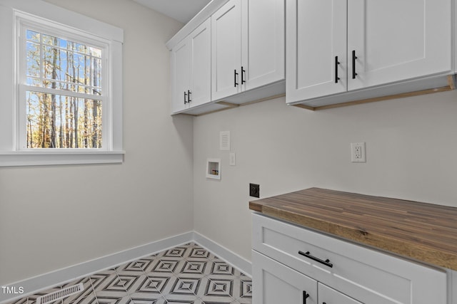 laundry room with washer hookup, cabinets, and hookup for an electric dryer