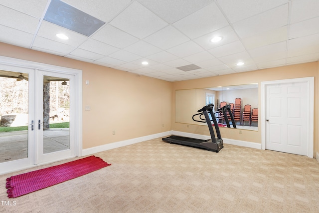 exercise area with light carpet, french doors, and a paneled ceiling