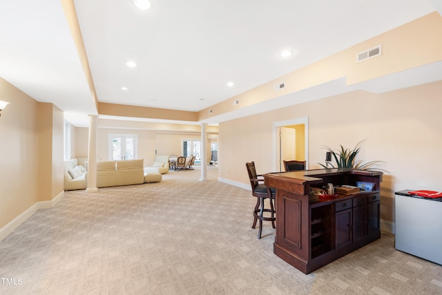 office featuring light carpet and decorative columns