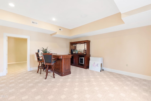 office with light colored carpet and indoor bar