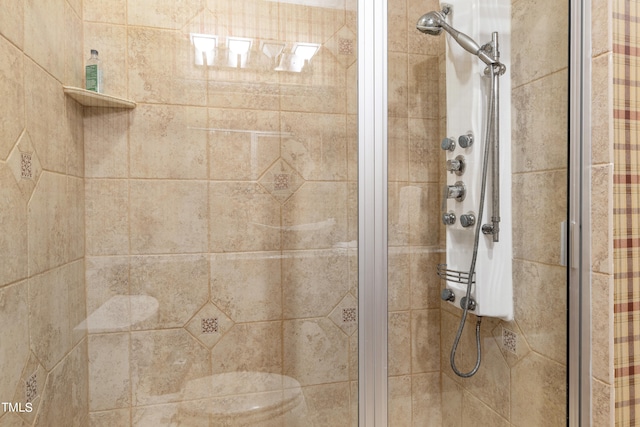 bathroom with toilet and an enclosed shower