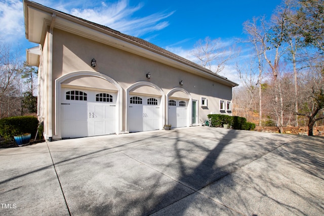 view of side of property with a garage