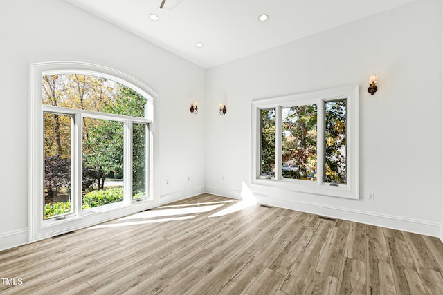 unfurnished room with a wealth of natural light and light hardwood / wood-style flooring